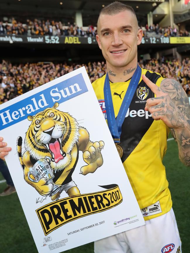 Richmond’s Dustin Martin holds the Mark Knight victory poster after the 2017 AFL Grand Final against the Adelaide Crows. Picture: Alex Coppel