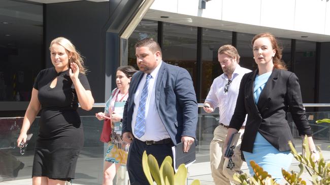 Rowan King of RK Law (centre) leaves the Toowoomba Courthouse following the first mention of a high-profile man charged with rape.