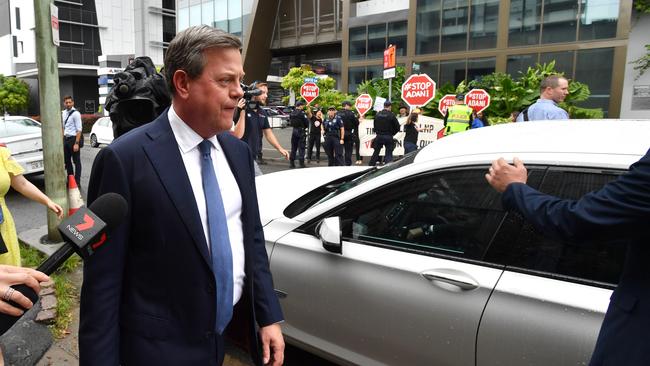 Tim Nicholls near the anti-Adani mine protesters outside the launch venue. Picture: AAP/Darren England