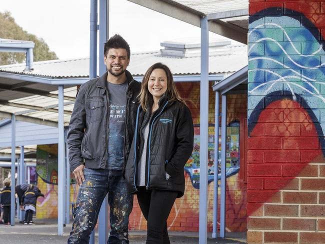 Artist-in-residence Rob Scholten helped Warranwood Primary School teacher Jeenah Metcalfe (right) and students with their new mural. Photo: Daniel Pockett