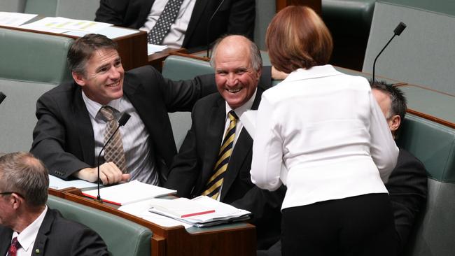 Independents Rob Oakeshott and Tony Windsor talk to PM Julia Gillard at the end of Question Time.