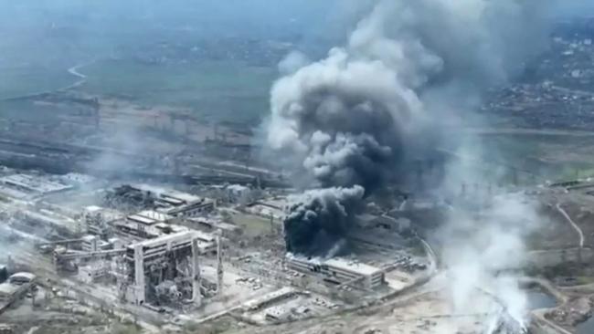 Clouds of smoke billowing above Azovstal steel plant and the destroyed gates of Azov Shipyard, Mariupol.