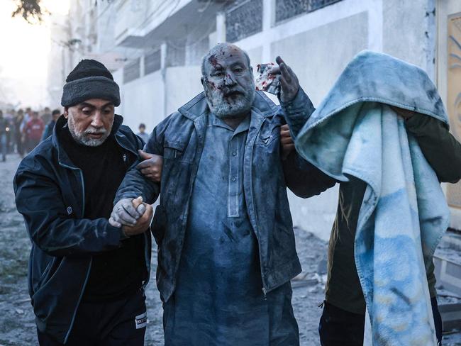 Palestinians help a man injured in an Israeli strike in Rafah in the southern Gaza Strip. Picture: Said Khatib/AFP