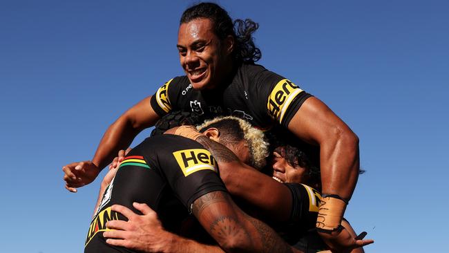 Jarome Luai jumps on the pack after a Viliame Kikau try in Dubbo (Photo by Mark Kolbe/Getty Images)