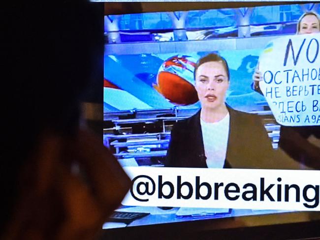 A man looks at a computer screen watching a dissenting Russian Channel One employee entering Ostankino on-air TV studio during Russia's most-watched evening news broadcast, holding up a poster which reads as "No War" and condemning Moscow's military action in Ukraine. Picture: AFP