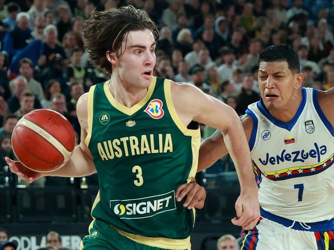 MELBOURNE, AUSTRALIA - AUGUST 14: Josh Giddey of the Boomers dribbles the ball under pressure from Jhornan Zamora of Venezuela during the match between Australia Boomers and Venezuela at Rod Laver Arena on August 14, 2023 in Melbourne, Australia. (Photo by Kelly Defina/Getty Images)