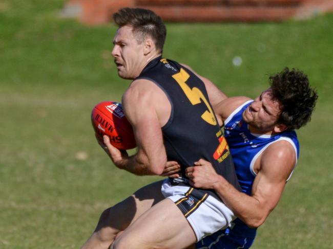 Adelaide Footy League division one match between St Peter's Old Collegians and Brighton Bombers at Caterer Oval (St Peter's College), August 1, 2020. St Peters (28 no name) tackles Brightons Nigel Osborn. Picture: Brenton Edwards