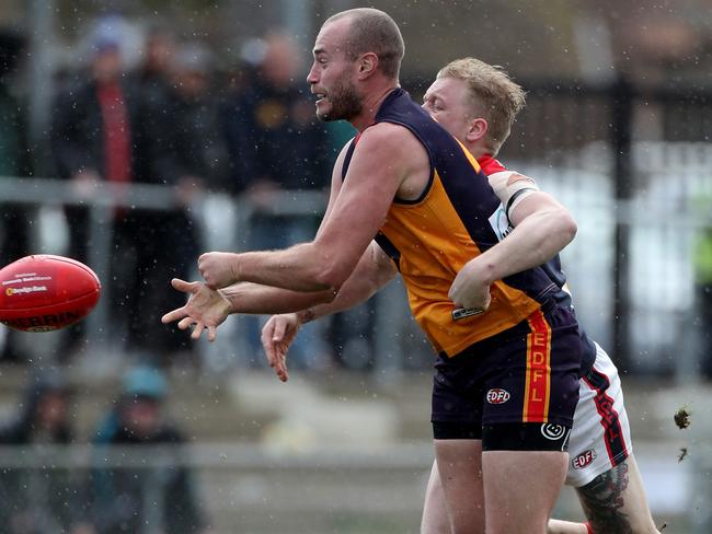 East Keilor gun Ash Arrowsmith fires off a handball. Picture: Mark Dadswell