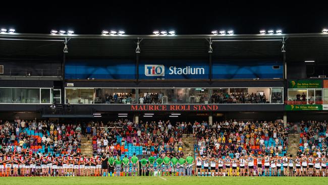 NTFL Buffaloes' mens side singing the Australian anthem with the Essendon Bombers. Picture: Pema Tamang Pakhrin