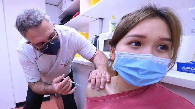 Emily Ngo receives an AstraZeneca vaccine injection from George James at his pharmacy in Fortitude Valley, Brisbane. Picture: Lyndon Mechielsen