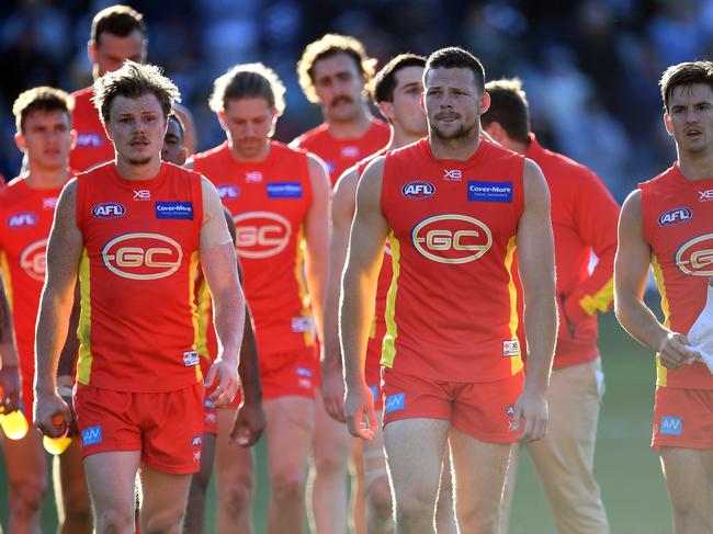 (L-R) Nick Holman, Steven May and Jarryd Lyons leaves the ground after the Round 23 AFL match between the Geelong Cats and the Gold Coast Suns at GMHBA Stadium in Geelong, Saturday, August 25, 2018. (AAP Image/Julian Smith) NO ARCHIVING, EDITORIAL USE ONLY