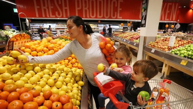 A customer stocks up on fresh fruit at Coles store in Sydney. (Image: Toby Zerna)