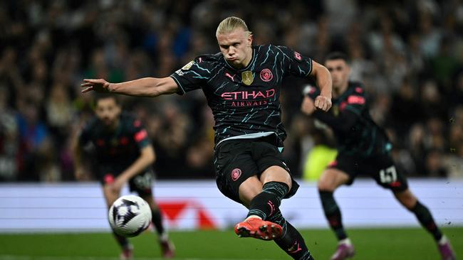 Erling Haaland shoots a penalty kick and scores his team second goal. Photo by Ben Stansall / AFP.