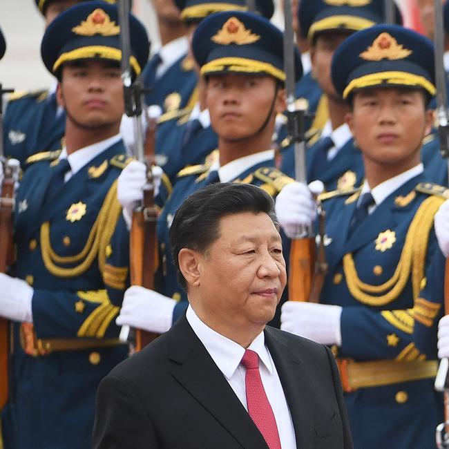 Chinese President Xi Jinping walking past a military honour guard during a diplomatic visit by Saudi Arabia outside the Great Hall of the People in Beijing.