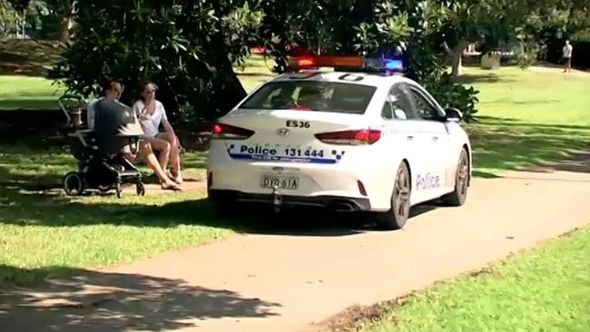 NSW police ask a family at a park in Sydney’s Rushcutters Bay to move on as part of the state's bid to enforce social distancing measures. Picture: Sky News