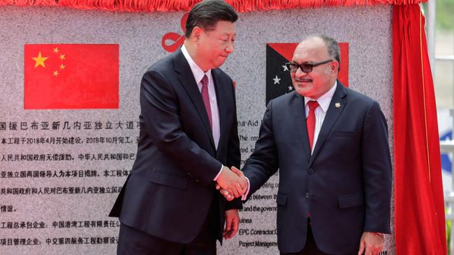 Chinese President Xi Jinping and PNG Prime Minster Peter O’Neill yesterday at the unveiling of a Chinese-funded road project in Port Moresby. Picture: AFP