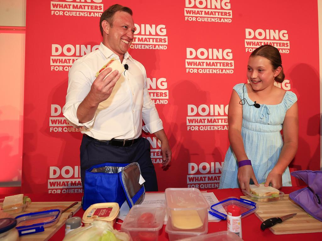 Premier Steven Miles with his daughter Bridie, 10, on stage on Sunday. Picture: Adam Head