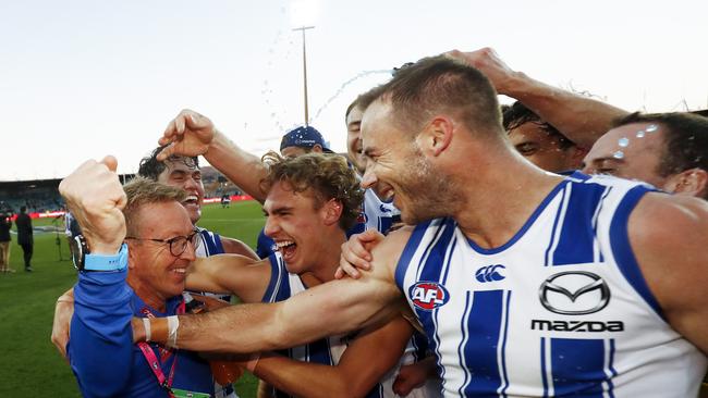 David Noble of the Kangaroos celebrates a win with his players in 2021. (Photo by Dylan Burns/AFL Photos via Getty Images)