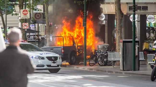 Ali’s burning vehicle in the CBD. Picture: Stuart Gaut.