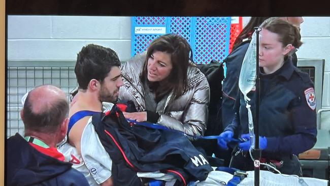 Christian Petracca on his way to hospital after the knee to the ribs.