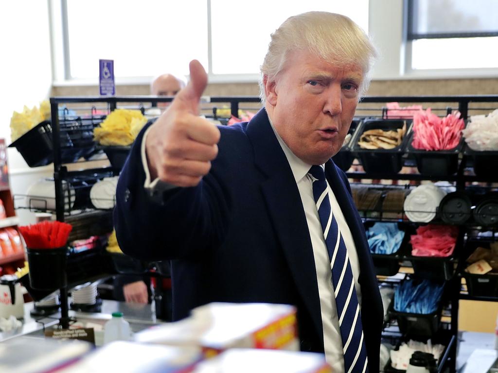 Republican presidential nominee Donald Trump gives a thumbs up to a reporter while stopping for snack food at a Wawa gas station on November 1, 2016 in Valley Forge, Pennsylvania. Picture: AFP