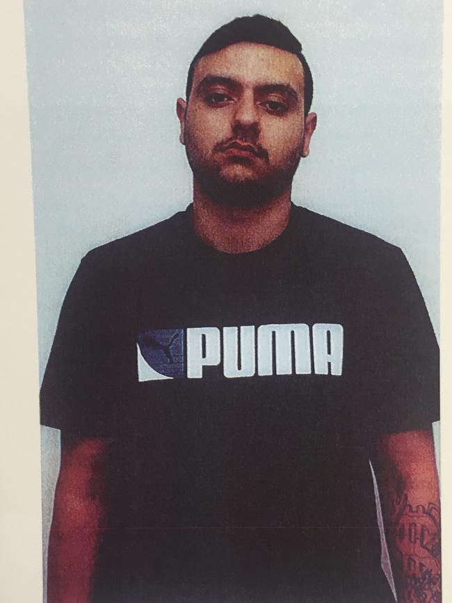 Jamil Qaumi, youngest of the Qaumi brothers, following his arrest on November 8, 2013. Police mugshot.