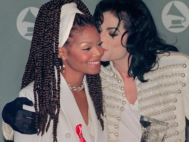 Close ... Michael Jackson kisses his sister Janet Jackson (L) after she presented him with the Grammy Legend Award in 1993.  Picture:  Supplied