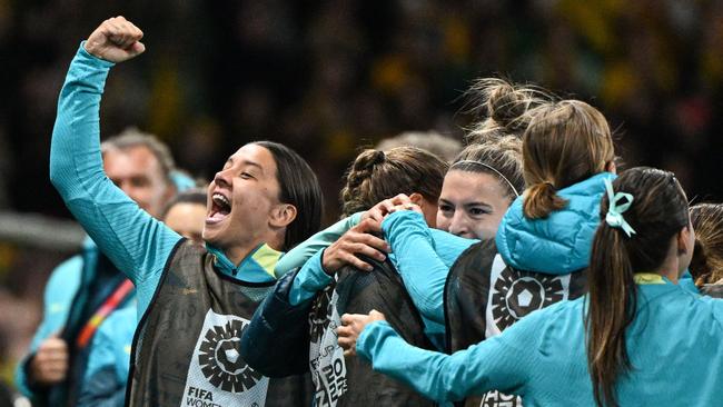 Sam Kerr celebrates with her teammates. Photo by WILLIAM WEST / AFP