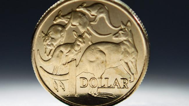 An Australian one-dollar coin is arranged for a photograph in Sydney, Australia, on Wednesday, April 17, 2013. Direct trading between the Australian dollar and yuan started on April 10. Photographer: Ian Waldie/Bloomberg