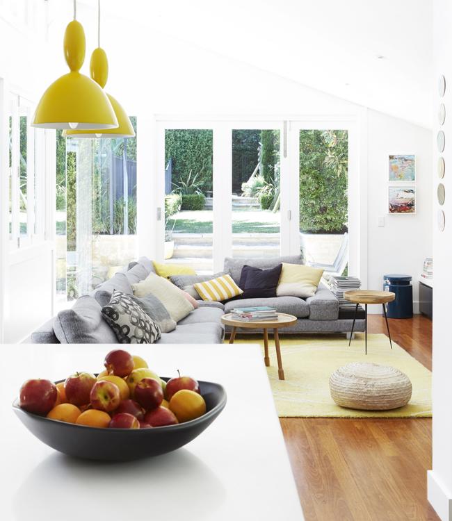 Muuto yellow pendants light up the living room. Picture: Zan Wimberley