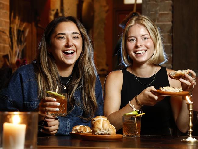 DAILY TELEGRAPH 24TH MARCH 2024Pictured at The Grounds in Alexandria is Abby Legg and Siri Place, enjoying Scotch Cross Buns, which are infused with whisky. Picture: Richard Dobson