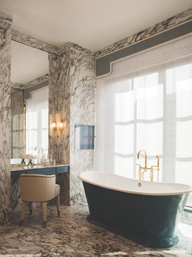 A roll-top tub takes centre stage in this marble-clad bathroom at Hotel Barrière Fouquet’s New York.