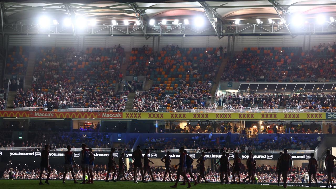 Players stand around after play was halted after the lighting failed. Picture: Chris Hyde/Getty Images