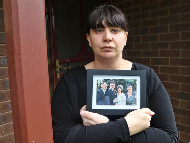 Epping resident Bianca Becker, younger sister of Apollo Papadopoulos, holds a photo from her wedding with Apollo on the left. Picture: Hamish Blair