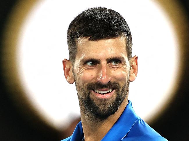 TOPSHOT - Serbia's Novak Djokovic reacts to a point against Spain's Carlos Alcaraz during their men's singles quarterfinal match on day ten of the Australian Open tennis tournament in Melbourne on January 22, 2025. (Photo by Martin KEEP / AFP) / -- IMAGE RESTRICTED TO EDITORIAL USE - STRICTLY NO COMMERCIAL USE --