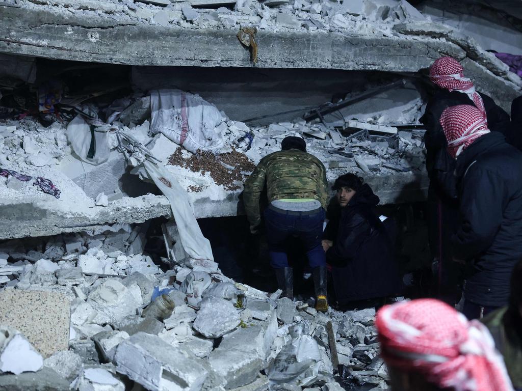 Residents search for victims and survivors amidst the rubble of a building that collapsed in the north of Syria's rebel-held northwestern Idlib province. Picture: AFP