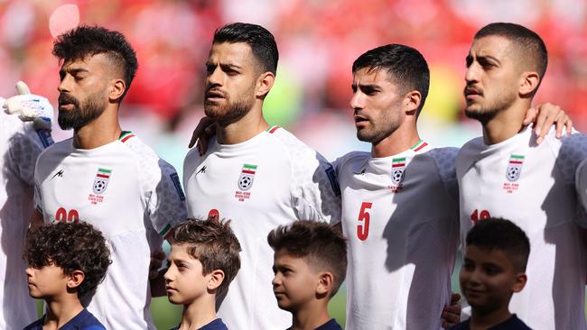 Iran players line up for the national anthem