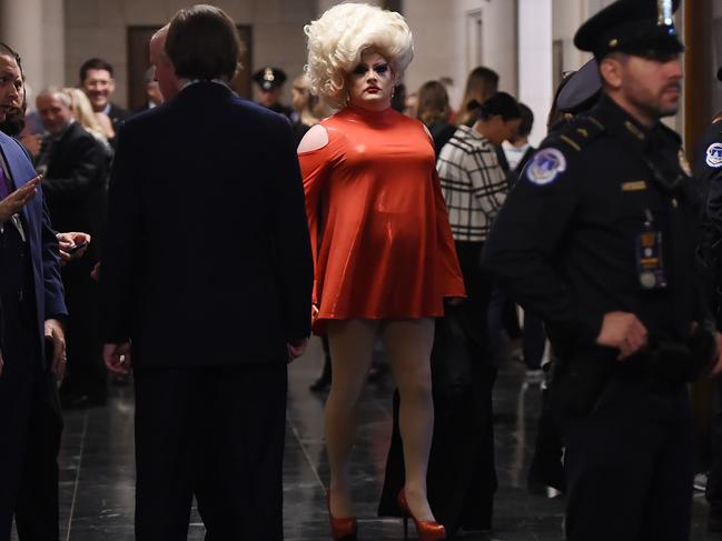 A drag queen stands in the hallway of the Longworth building as people await the arrival of the first two witnesses to testify before the House Intelligence Committee for the first public impeachment hearing of US President Donald Trump. Picture: AFP