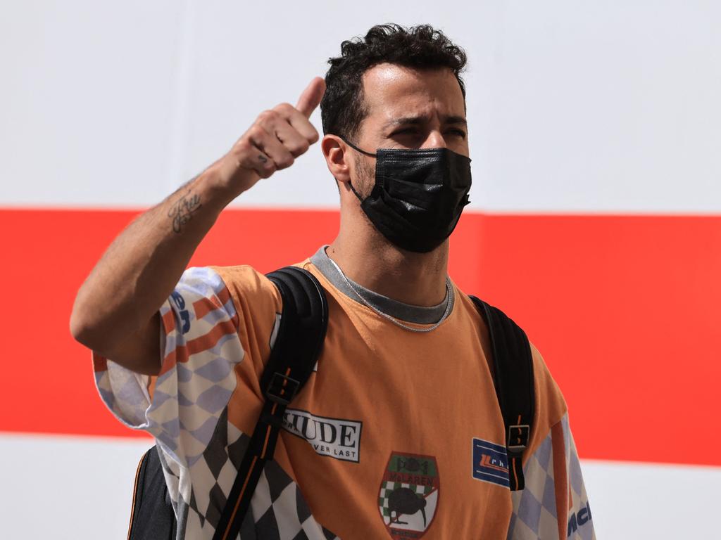 McLaren's Australian driver Daniel Ricciardo arrives at the track ahead of the practice session of the Abu Dhabi Formula One Grand Prix at the Yas Marina Circuit in the Emirati city of Abu Dhabi on December 9, 2021. (Photo by Giuseppe CACACE / AFP)