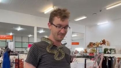 Snake enthusiast Youknowthatoneguywho on TikTok alongside the thrifty snake. Picture: Supplied