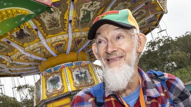 Photographer Robert Brown explores sideshow alley on day 3 of the Toowoomba Royal Show. Sunday, March 27, 2022. Picture: Nev Madsen.