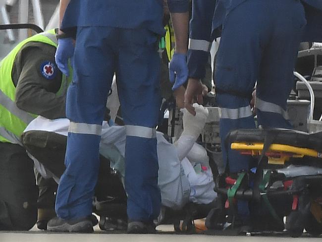 Medics attend to a survivor that arrived at Sydney Airport. Picture: AAP