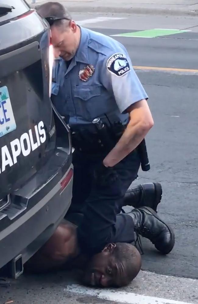 George Floyd is pinned to the street by the knee of white cop Derek Chauvin. Picture: AFP