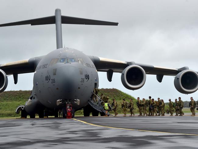 ADF soldiers board a C-17 Globemaster at RAAF Townsville to the Solomon Islands. Picture: Evan Morgan