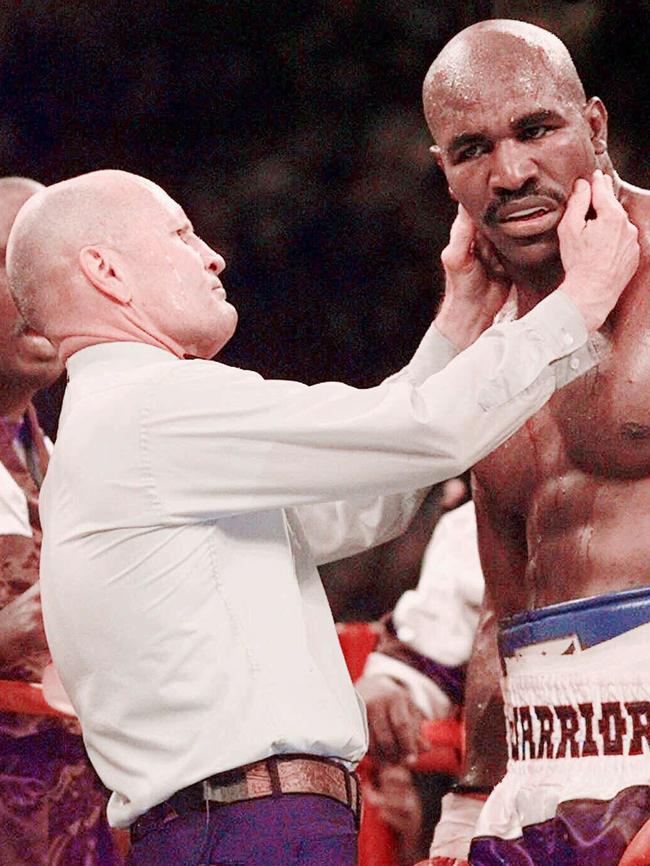 Referee Mills Lane checks on Holyfield. Picture: AP/Mark J. Terrill