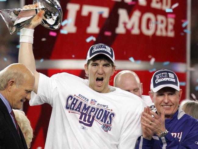 Eli Manning celebrates with the Vince Lombardi Trophy alongside then Giants head coach Tom Coughlin in 2008.