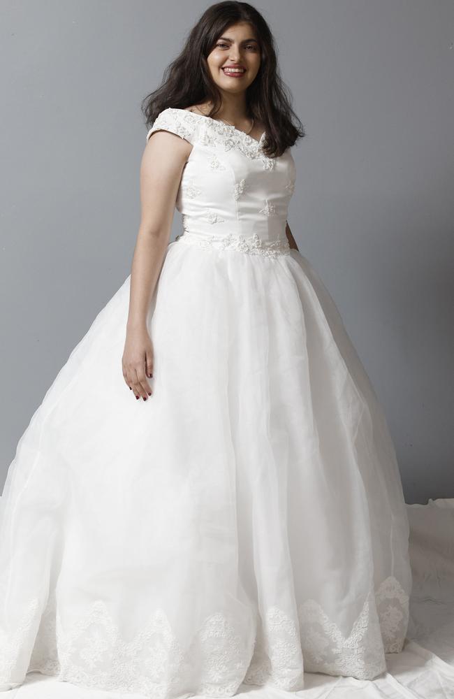 Kristy Fava models a wedding dress that is on sale for $200 from the St Vincent de Paul Society's opportunity shop at the Showgrounds Shopping Centre, Mulgrave Road, Bungalow. Picture: Brendan Radke