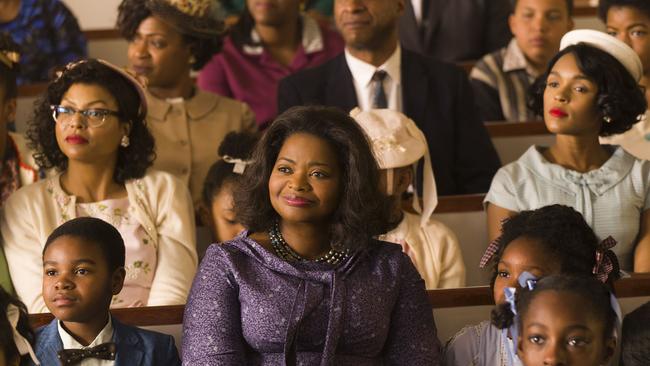 This image released by Twentieth Century Fox shows Taraji P. Henson, background left, Octavia Spencer, center, and Janelle Monae, background right, in a scene from "Hidden Figures." (Hopper Stone/Twentieth Century Fox via AP)