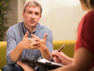 Mature man in therapy explains to therapist