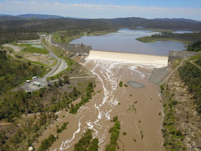 Water flows over the wall at the capacity-reduced Paradise Dam after years of drought. Picture: SunWater